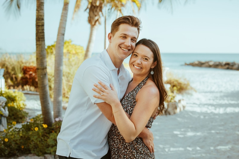 Elopement photographer, a couple hold each other close as they smile at the beach